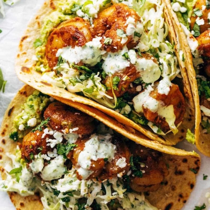 Spicy shrimp tacos with sauce.